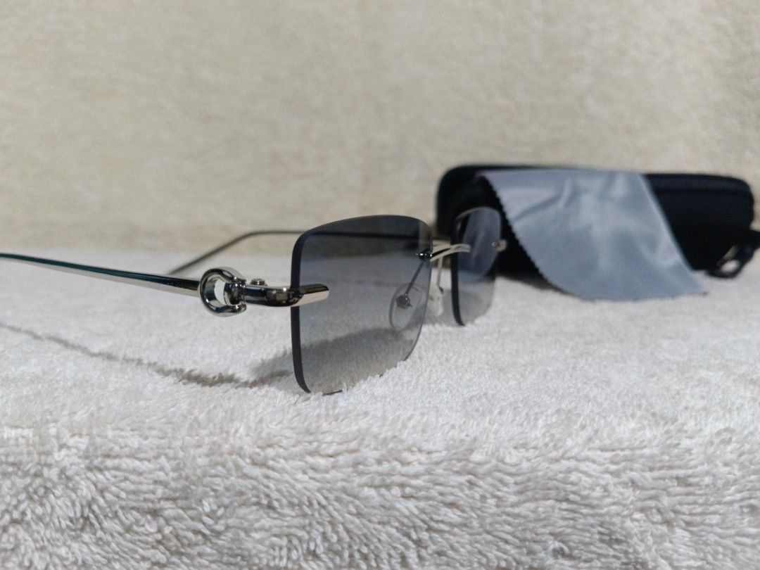 Cartier Rimless Sunglasses 2212 (Category: Sunglasses & Eyewear) located in Cavite. Submitted by navias (Listing ID 1467420939, Image 3). Description: - Authentic Cartier rimless sunglasses (Model: 2212, Made in Italy) - Silver frame with stylish gradient blue lenses - Rectangular, frameless design with classic metal hinge hardware - Pristine condition: clean lenses with zero scratches - Inclusions: Black hard case and cleaning cloth - Perfect fo