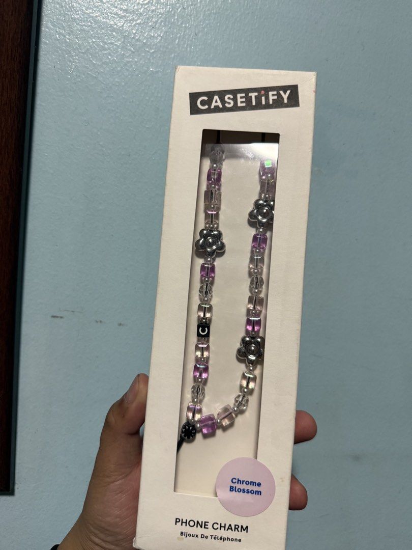 Casetify Chrome Blossom Phone Charm (Category: Cases & Sleeves) located in Manila. Submitted by maema97 (Listing ID 1467445319, Image 1). Description: - Brand: Casetify - Design: Chrome Blossom - Details: Purple and silver beads with floral accents and signature 'C' letter cube - Packaging: Complete with original white retail box.