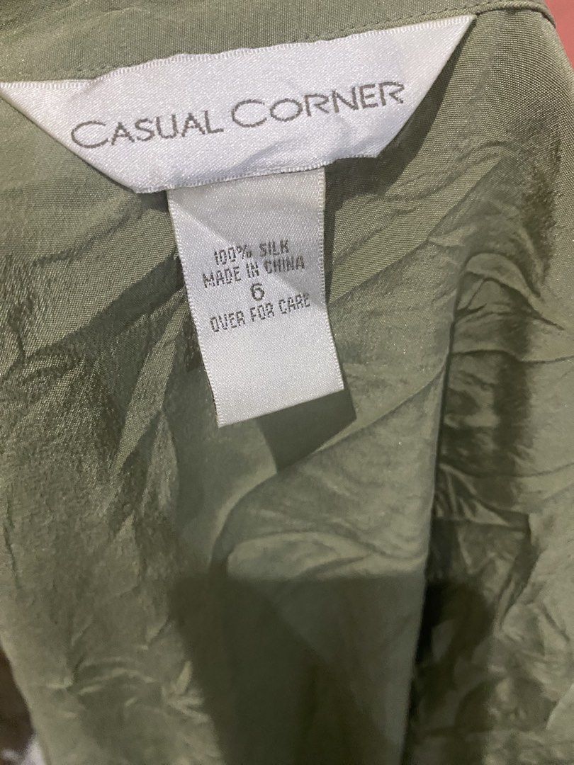 Casual Corner Green Silk Button Down Shirt Size 6 (Category: Shirts) located in Pulupandan. Submitted by pointyspoon (Listing ID 1467464666, Image 2). Description: - Brand: Casual Corner - Size: 6 - Material: 100% Silk with textured finish - Color: Olive green - Style: Short-sleeve button-down with classic collar and white front buttons - Condition: Great versatile staple for office or casual outfits.