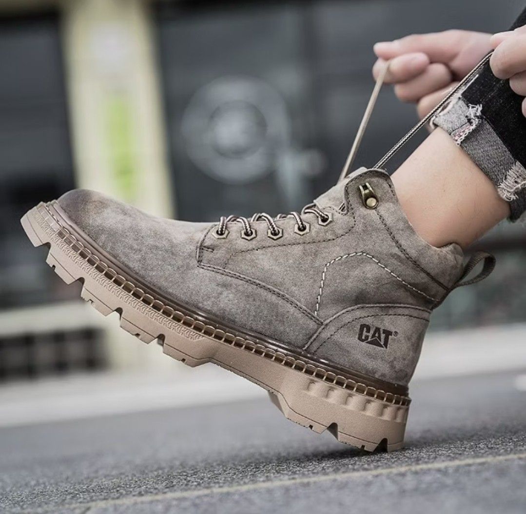 CAT Caterpillar Grey Suede Ankle Boots (Category: Boots) located in San Mateo. Submitted by reyshel08 (Listing ID 1467391354, Image 1). Description: CAT Caterpillar suede boots in grey. Durable lug soles in light brown with good traction. Lace-up closure with patterned brown and white laces. Padded ankle collar with patterned lining inside. Pull tab at the back heel for easy wear. Distinct CAT logo stamped on the side and tongue. Sturdy construct