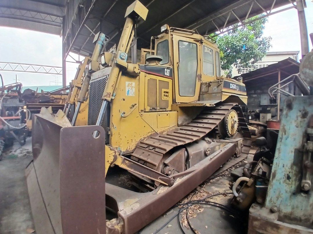 Caterpillar D6R Bulldozer (Category: Construction Tools & Equipment) located in Manila. Submitted by joseph.and.rona (Listing ID 1467504062, Image 3). Description: - Model: Caterpillar D6R XR Bulldozer - Color: Yellow - Mobility: Heavy crawler tracks on both sides for superior traction - Equipment: Large front-mounted blade and rear ripper attachment - Operator Area: Open-air cab setup with comfortable operator seat - Condition: Used heavy machin