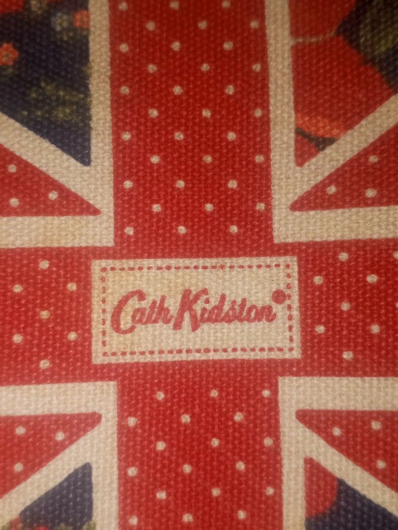 Cath Kidston British Union Jack Wristlet Pouch Bag (Category: Purses & Pouches) located in Magalang. Submitted by zeiansoria64090 (Listing ID 1467367134, Image 2). Description: - Brand: Cath Kidston - Design: Iconic Union Jack and London bus pattern on navy blue - Features: Secure zip top closure and attached fabric wrist strap - Interior: Clean dark blue fabric lining - Condition: Excellent / Well-maintained - Perfect for: Carrying small daily e