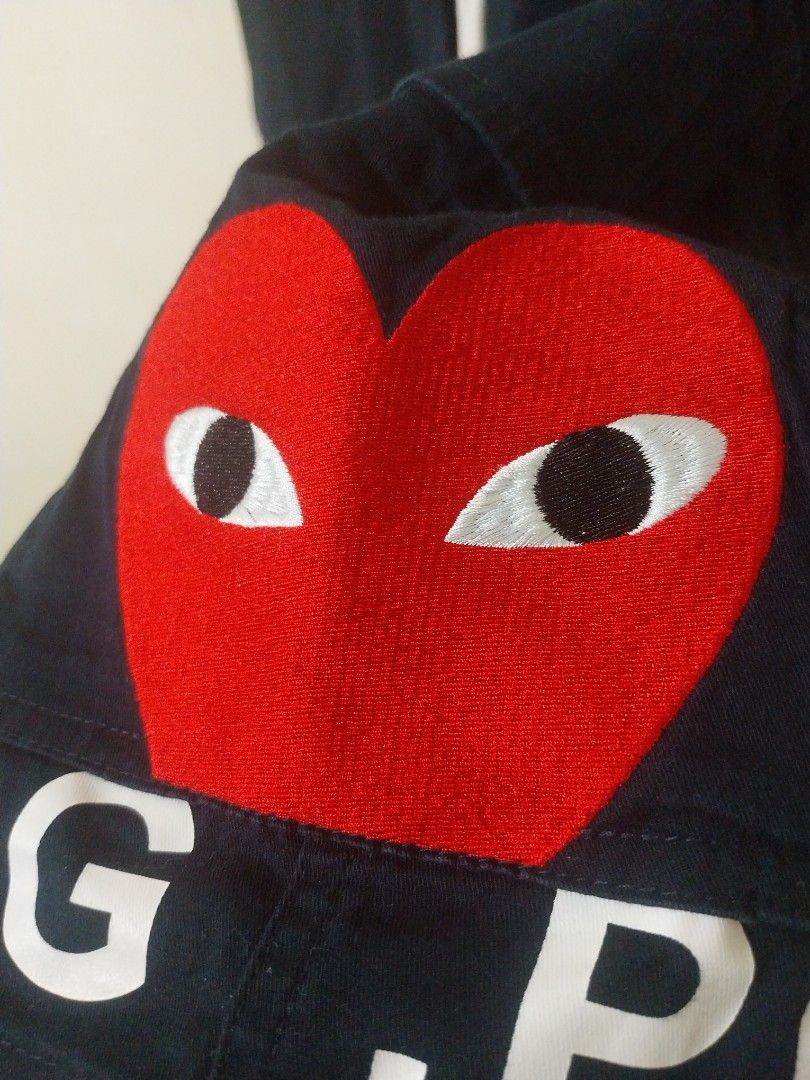 CDG Play Navy Shorts Size L (Category: Shorts) located in Davao. Submitted by thegraildept2026 (Listing ID 1467547895, Image 3). Description: - Brand: Comme des Garçons Play (CDG Play) - Color: Dark Navy Blue - Size: L (Fits true to size) - Details: Signature embroidered red heart patch with eyes, bold CDG lettering down the leg - Features: Elastic waistband, adjustable white drawstrings, and CDG-stamped metal aglets - Condition/Style: Casual str