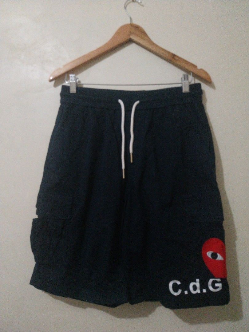 CDG Play Navy Shorts Size L (Category: Shorts) located in Davao. Submitted by thegraildept2026 (Listing ID 1467547895, Image 1). Description: - Brand: Comme des Garçons Play (CDG Play) - Color: Dark Navy Blue - Size: L (Fits true to size) - Details: Signature embroidered red heart patch with eyes, bold CDG lettering down the leg - Features: Elastic waistband, adjustable white drawstrings, and CDG-stamped metal aglets - Condition/Style: Casual str