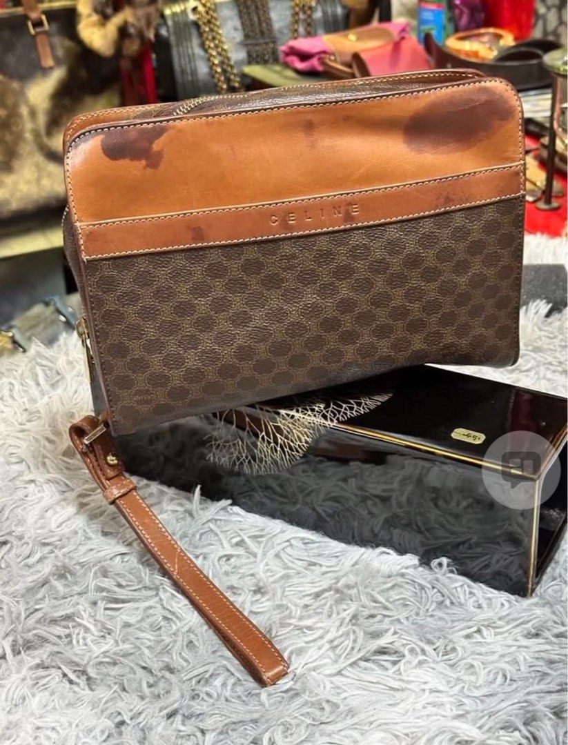 Celine Macadam Brown Monogram Clutch Bag (Category: Luxury Bags & Wallets) located in Dipolog. Submitted by adrian281994 (Listing ID 1467388188, Image 1). Description: - Brand: Celine - Material: Brown Macadam monogram coated canvas with tan leather trim - Closure: Zip top - Features: Removable wrist strap, dark fabric interior lining, and interior slip pocket - Origin: Made in Italy, stamped leather tag with serial code CE00/13 - Condition: Visi