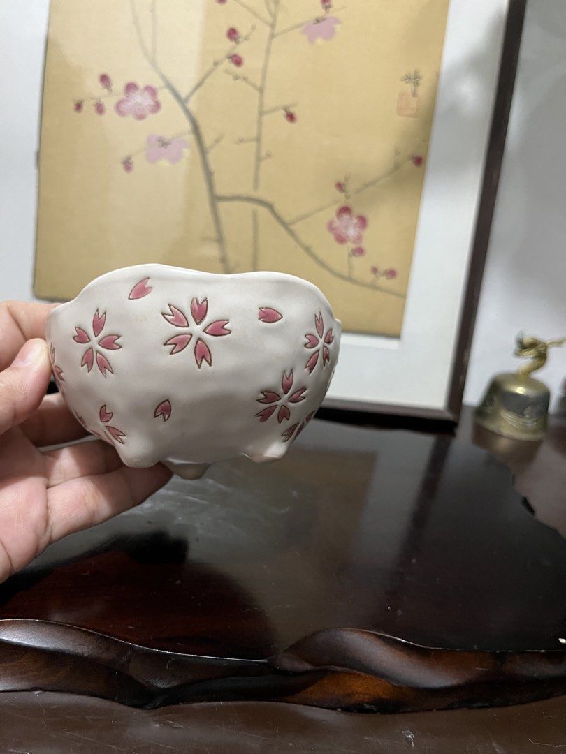 Ceramic Bowl with Pink Cherry Blossom Pattern (Category: Dinnerware & Cutlery) located in Taguig. Submitted by minmin_parker (Listing ID 1467475892, Image 1). Description: - Design: White ceramic bowl adorned with delicate pink cherry blossom motifs - Details: Features elegant scalloped rim edges and a small footed base - Finish: Smooth glazed finish with gentle, artisanal indentations on the body - Size & Use: Handy small size, ideal for serving