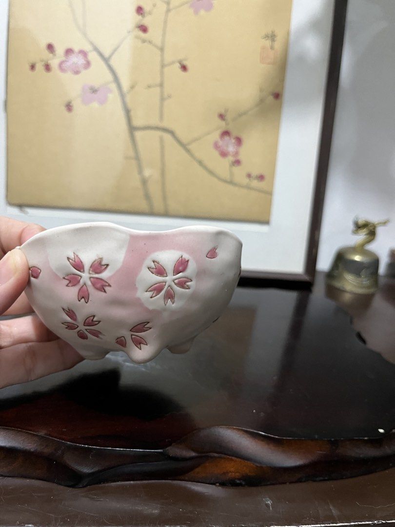 Ceramic Bowl with Pink Cherry Blossom Pattern (Category: Dinnerware & Cutlery) located in Taguig. Submitted by minmin_parker (Listing ID 1467475892, Image 2). Description: - Design: White ceramic bowl adorned with delicate pink cherry blossom motifs - Details: Features elegant scalloped rim edges and a small footed base - Finish: Smooth glazed finish with gentle, artisanal indentations on the body - Size & Use: Handy small size, ideal for serving