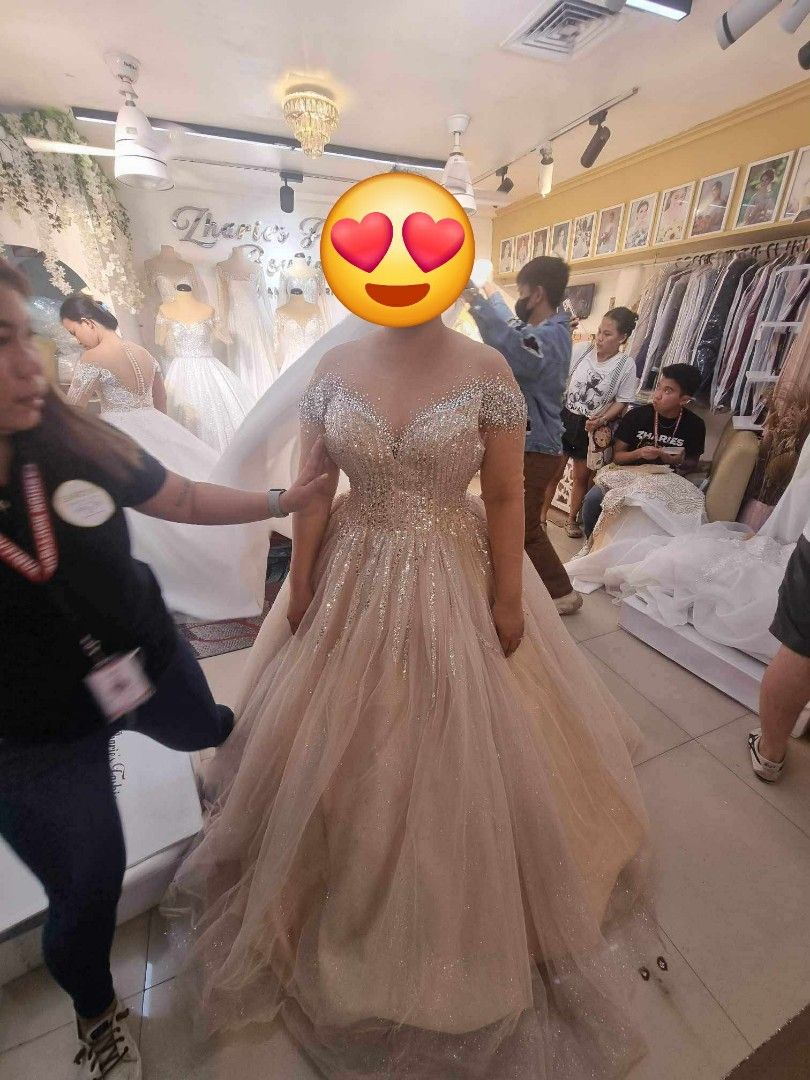 Champagne Wedding Gown (Category: Evening dresses & gowns) located in Manila. Submitted by euladelosr38638 (Listing ID 1467578873, Image 1). Description: Selling my UNUSED wedding gown from Zharie's Fashion Boutique Color: Champagne Size Medium to Large (adjustable cross-back) Glittered Tulle Long trail This was RTW pero pinaconvert ko to longsleeves/off shoulder style and cross back. The second photo is the actual photo and length (before alteri
