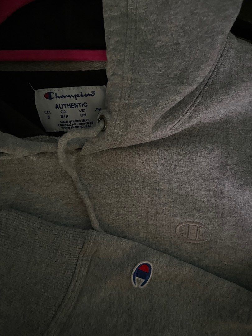 Champion Grey Authentic Hoodie Size S (Category: Hoodies) located in Davao. Submitted by vin.my (Listing ID 1467372312, Image 2). Description: Grey Champion hoodie with drawstring hood and front pouch pocket. Small embroidered Champion logo on the left chest and classic patch logo on the left sleeve cuff. Made in Honduras. Size small tag attached. Cotton blend fabric, warm and comfortable for daily wear..