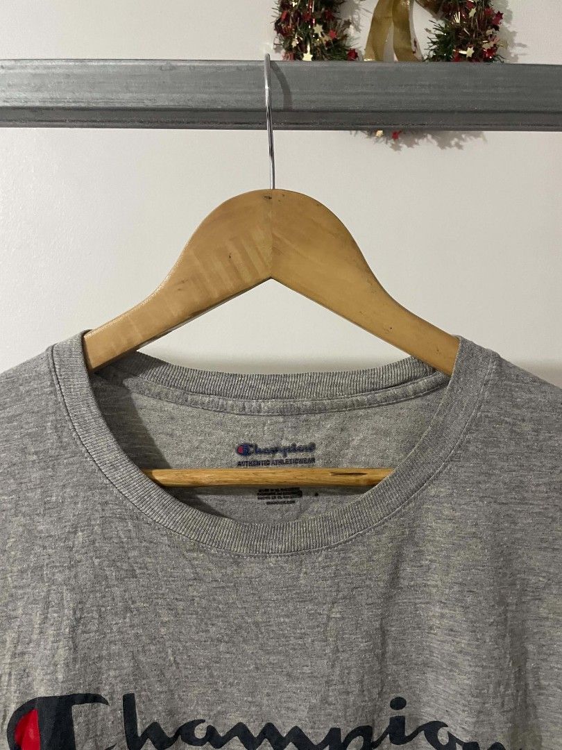 Champion Heather Grey Script Logo T-Shirt Medium (Category: Tshirts & Polo Shirts ) located in Manila. Submitted by mikeee03 (Listing ID 1467585765, Image 3). Description: - Brand: Champion - Color: Heather Grey - Size: Medium (tag on inner collar) - Design: Large script logo across chest with iconic embroidered C patch on left sleeve - Material: Soft, comfortable cotton blend - Origin: Made in El Salvador - Condition: Excellent, no stains or tea