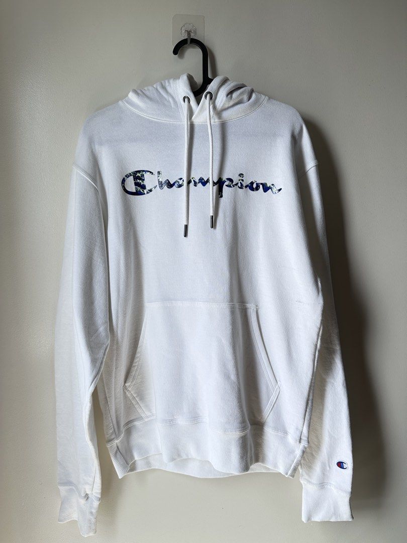 Champion White Hoodie with Earth Print Script Logo (Category: Hoodies) located in Mandaluyong City. Submitted by phvllis_ (Listing ID 1467450246, Image 1). Description: - Brand: Champion - Color: White with grey hood lining - Design: Script logo with blue and green earth print - Size: USA Small / Asia Large - Features: Kangaroo pocket, drawstring hood with metal aglets, embroidered C logo on left cuff - Origin: Made in El Salvador - Condition: Ex