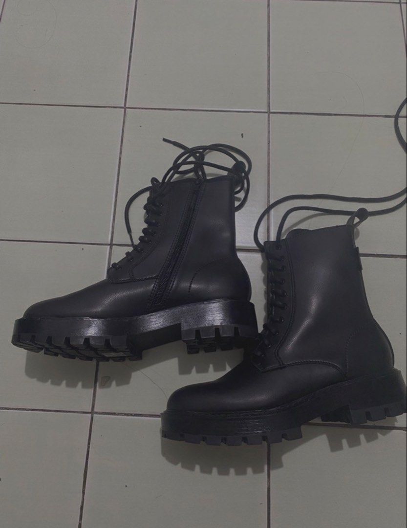 Charles & Keith Black Combat Boots Size 36 (Category: Boots) located in Manila. Submitted by xy.ly (Listing ID 1467522829, Image 2). Description: - Brand: Charles & Keith - Size: 36 - original price (8k) - Color: Matte black finish - Design: Lace-up front with convenient inner side zipper and back pull tab - Sole: Chunky lug sole, sturdy heel, and clean tread with minimal wear - Condition: Solid construction and well-maintained.