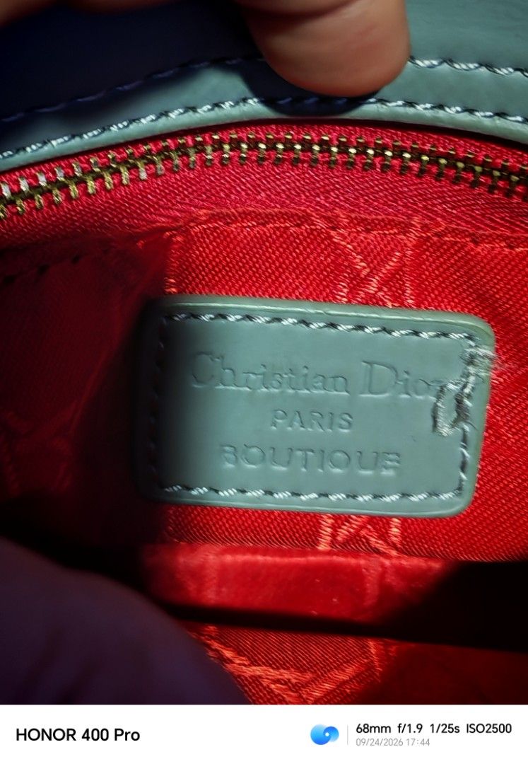 Christian Dior Lady Dior Mini Bag (Category: Luxury Bags & Wallets) located in Manila. Submitted by cleverwhale_45b7bc (Listing ID 1467375110, Image 2). Description: - Christian Dior mini handbag - Color: Light grey - Material: Quilted leather exterior - Interior: Red fabric with a zippered pocket - Embellishments: Iconic Dior charms - Condition: Shows some signs of wear on handles and corners, still beautiful..