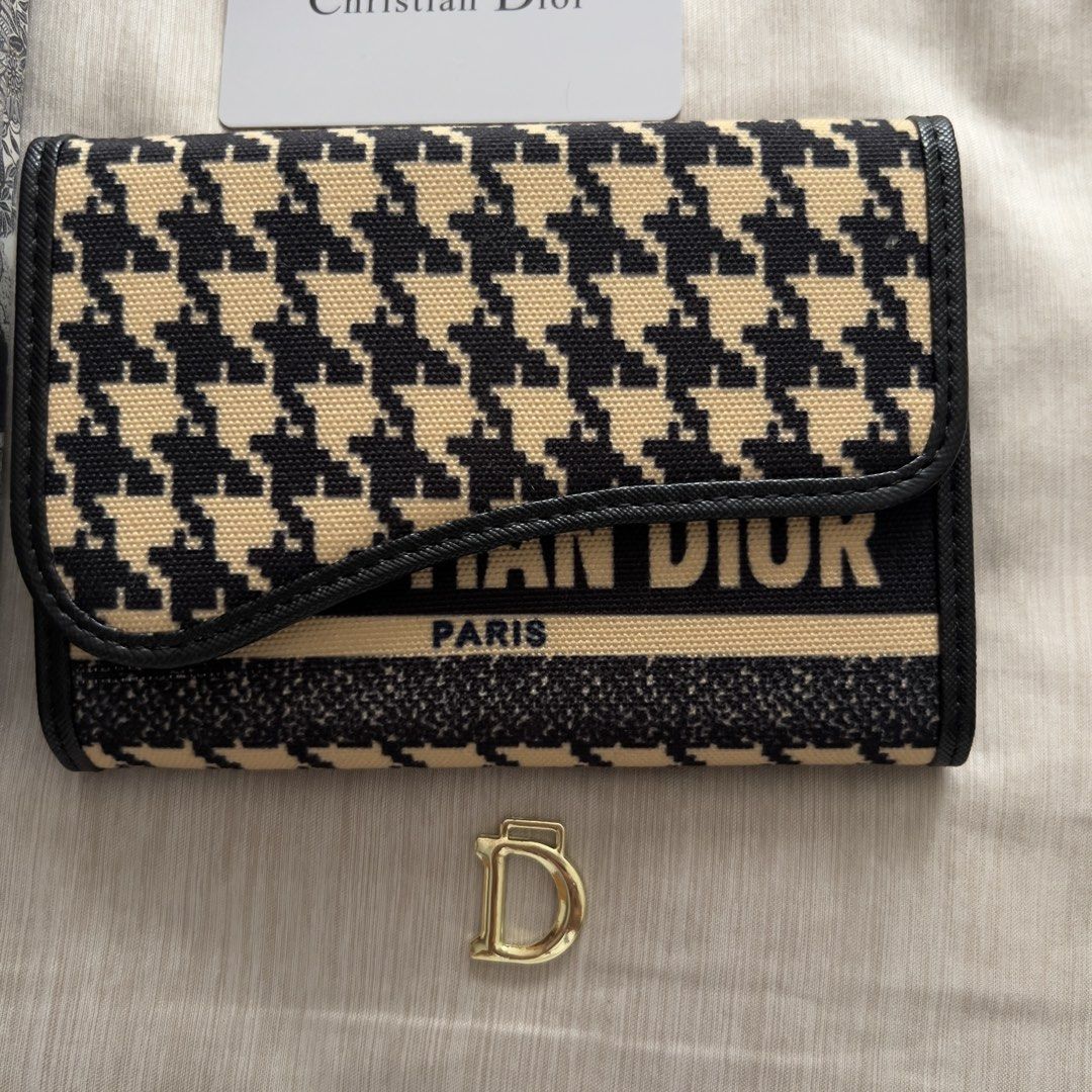 Christian Dior Saddle Wallet Houndstooth Black Beige (Category: Luxury Bags & Wallets) located in Pasig City. Submitted by jenscloset86 (Listing ID 1467389930, Image 3). Description: Christian Dior • Gifted to me, never used and it’s been in the box for long time. • The gold “D” is detached. • I cannot guarantee authenticity. • Please self-authenticate. Measurement (in inches): Length: 6” Height: 4.25”.