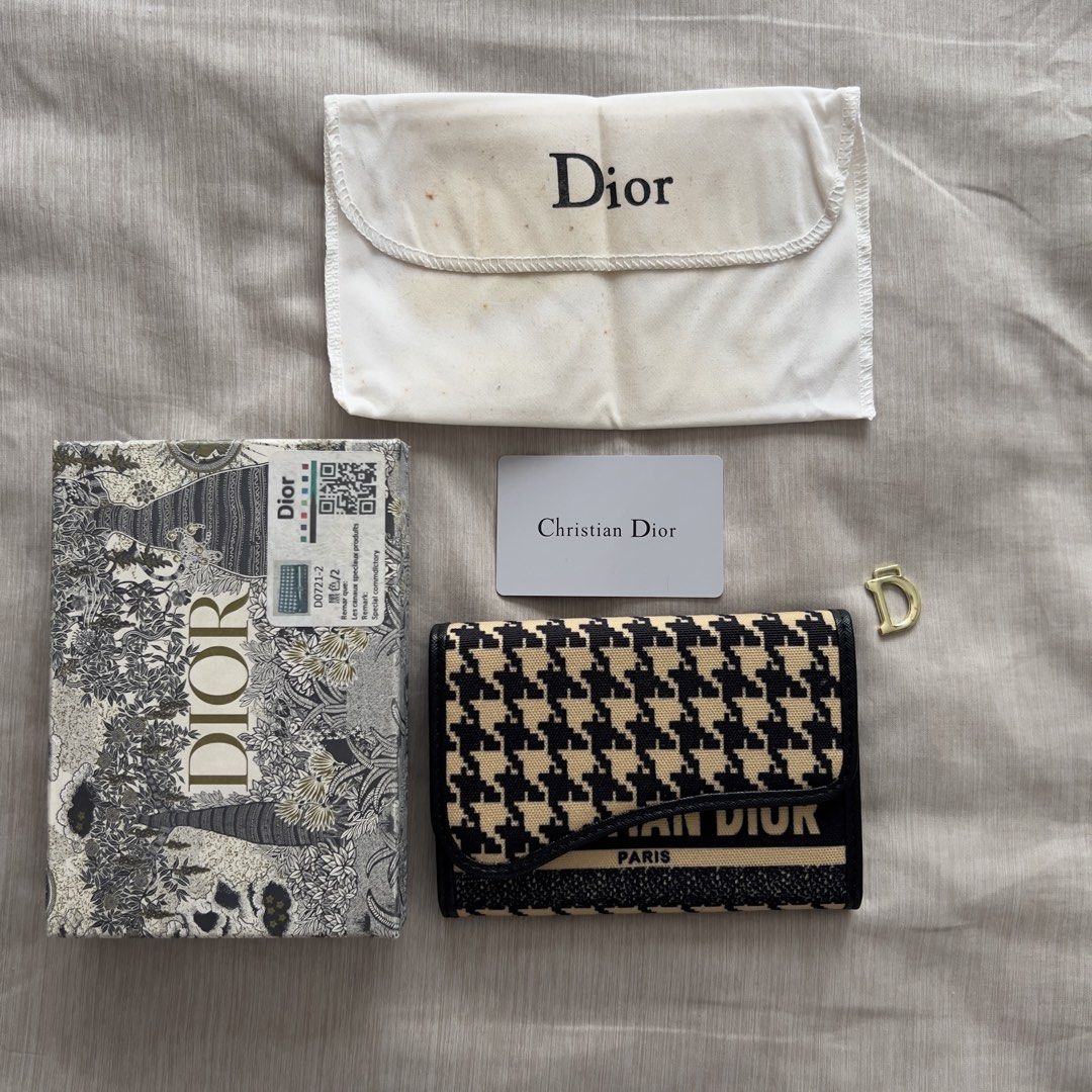Christian Dior Saddle Wallet Houndstooth Black Beige (Category: Luxury Bags & Wallets) located in Pasig City. Submitted by jenscloset86 (Listing ID 1467389930, Image 1). Description: Christian Dior • Gifted to me, never used and it’s been in the box for long time. • The gold “D” is detached. • I cannot guarantee authenticity. • Please self-authenticate. Measurement (in inches): Length: 6” Height: 4.25”.