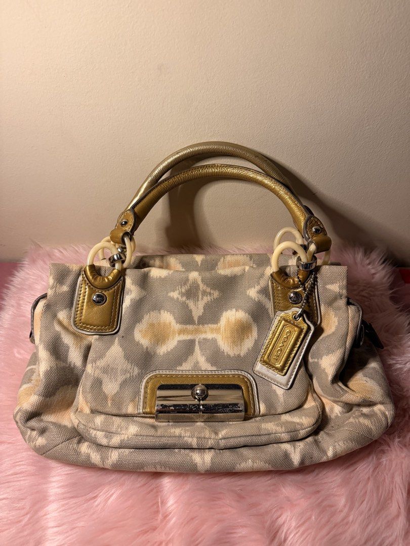 coach bag (Category: Shoulder Bags) located in Daraga. Submitted by littlemissdeclutter.wtme (Listing ID 1467576759, Image 1). Description: Coach Kristin Op Art I-Cat Print satchel handbag. A grey and multi-color signature Op Art pattern on canvas or sateen fabric with leather trim and gold-tone hardware. The bag has double top handles for hand or elbow carry and may include a detachable shoulder strap (not inlcuded). ⁃ kindly manage your expecta