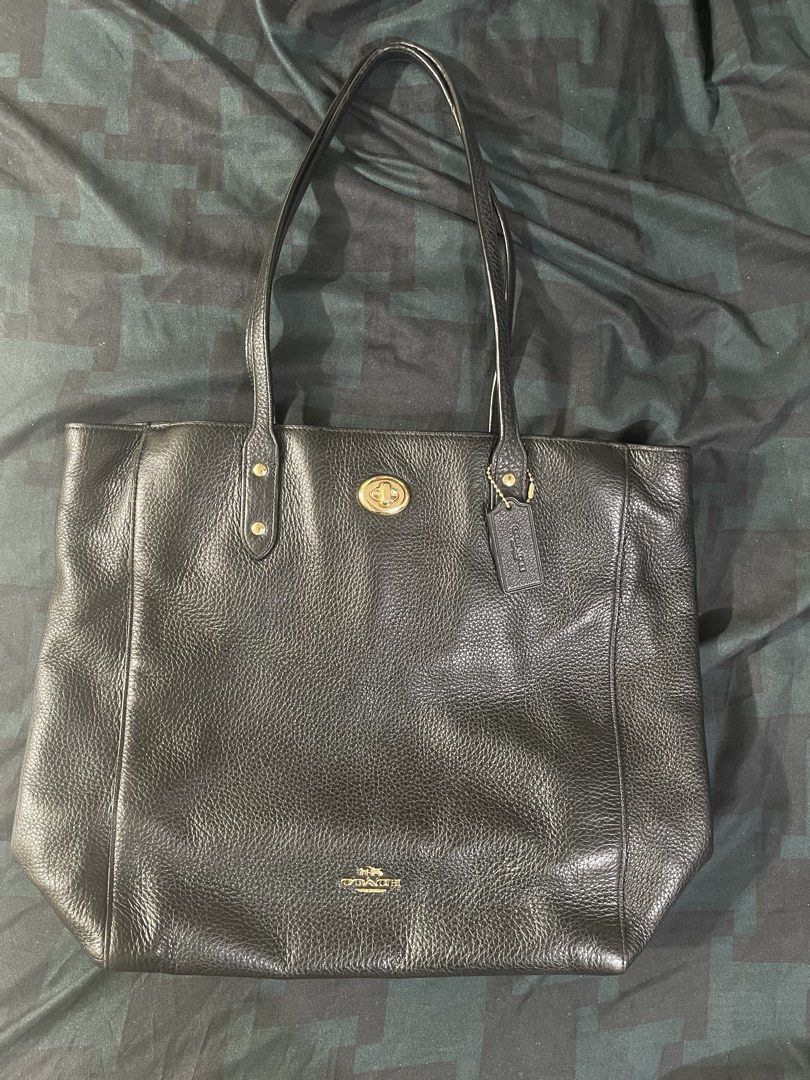 Coach Black Leather Tote Bag (Category: Tote Bags) located in Cavite. Submitted by winterbabyj (Listing ID 1467458251, Image 3). Description: - E1792-F12184 - Authentic Coach black pebble leather tote bag - Elegant gold-tone hardware with a secure turnlock closure - Dual comfortable shoulder straps for easy carrying - Iconic horse and carriage logo stamped on the front with included hangtag - Spacious interior ideal for daily essentials, work, or