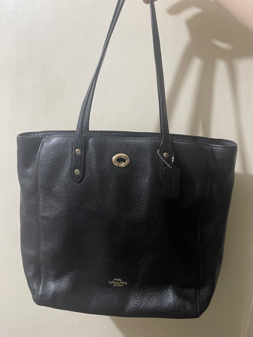 Coach Black Leather Tote Bag (Category: Tote Bags) located in Cavite. Submitted by winterbabyj (Listing ID 1467458251, Image 1). Description: - E1792-F12184 - Authentic Coach black pebble leather tote bag - Elegant gold-tone hardware with a secure turnlock closure - Dual comfortable shoulder straps for easy carrying - Iconic horse and carriage logo stamped on the front with included hangtag - Spacious interior ideal for daily essentials, work, or