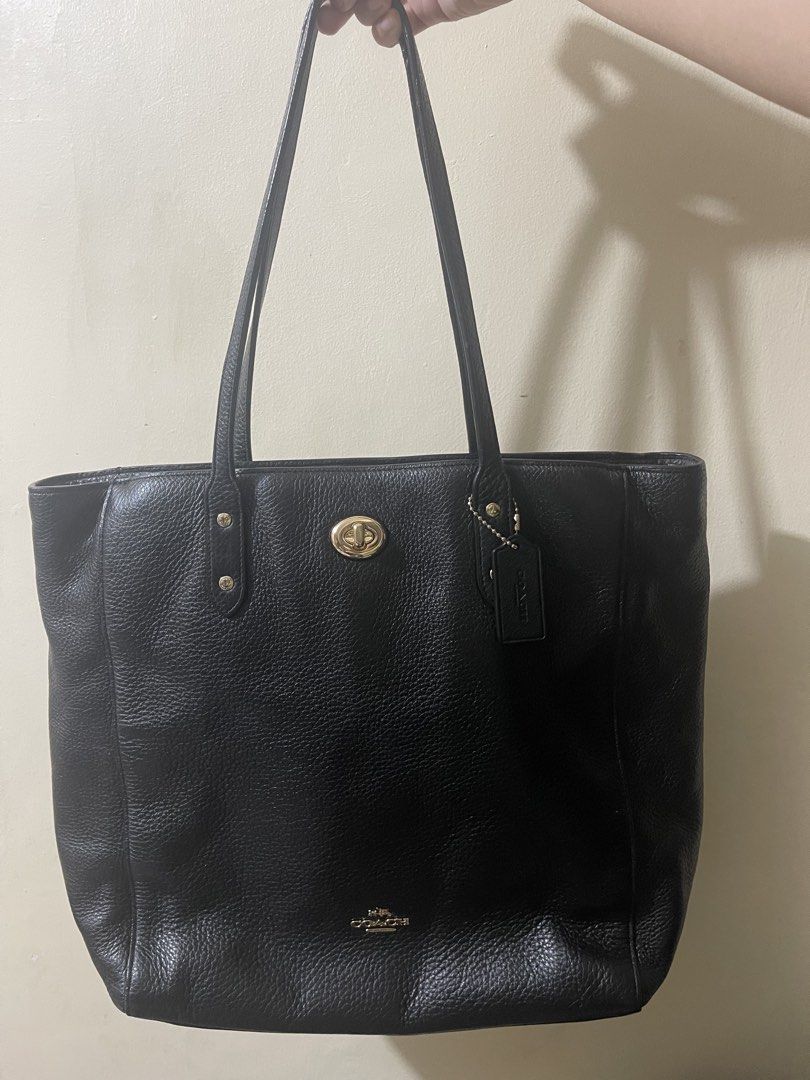 Coach Black Leather Tote Bag (Category: Tote Bags) located in Cavite. Submitted by winterbabyj (Listing ID 1467458251, Image 2). Description: - E1792-F12184 - Authentic Coach black pebble leather tote bag - Elegant gold-tone hardware with a secure turnlock closure - Dual comfortable shoulder straps for easy carrying - Iconic horse and carriage logo stamped on the front with included hangtag - Spacious interior ideal for daily essentials, work, or