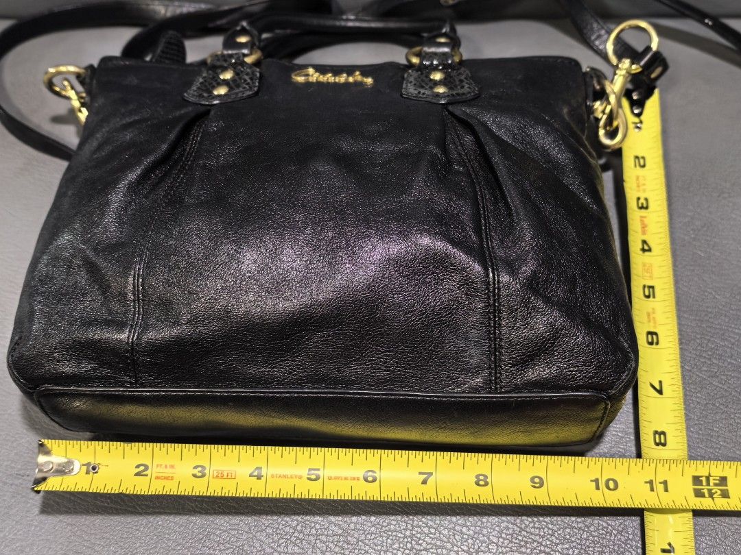 Coach Black Leather Tote Handbag (Category: Luxury Bags & Wallets) located in Cagayan de Oro. Submitted by pootx (Listing ID 1467512051, Image 2). Description: -please check last photos sa issue - Brand: Coach - Color: Classic Black with luxurious gold hardware - Material: Genuine leather - Carry Options: Double top handles and an adjustable/detachable shoulder strap - Closure: Secure zip top closure - Interior: Fabric lining with a zippered pock