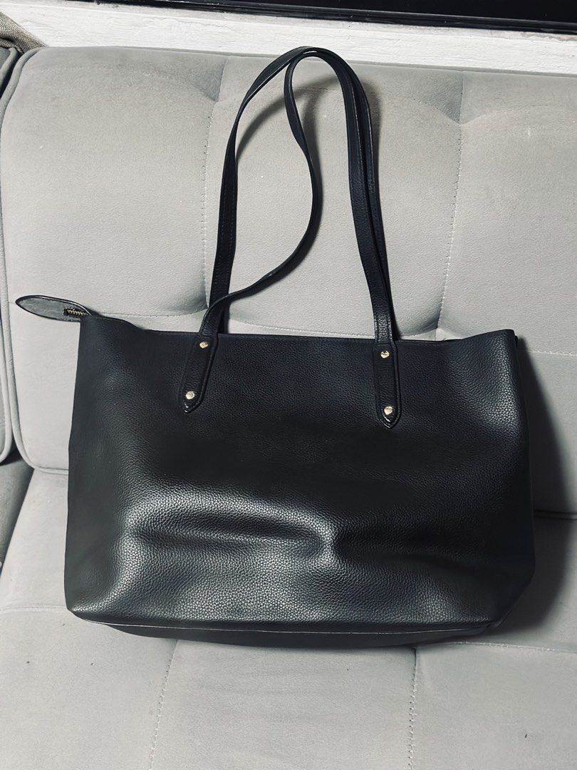 Coach Black Pebbled Leather Tote Bag (Category: Luxury Bags & Wallets) located in Tarlac. Submitted by via_banana (Listing ID 1467427594, Image 2). Description: - Authentic Coach black pebbled leather tote bag - Secure zip-top closure keeps your belongings safe - Elegant gold-tone hardware and front logo accents - Spacious interior easily holds laptops, notebooks, and daily gear - Comfortable dual shoulder straps for easy carrying - Structured de