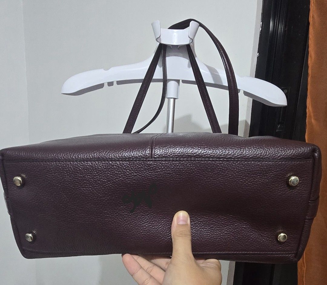 Coach Pebbled Leather Gallery Tote Bag (Category: Luxury Bags & Wallets) located in Cabuyao City. Submitted by grasiyas (Listing ID 1467491586, Image 3). Description: - Authentic Coach tote bag in a stunning deep purple pebbled leather - Elegant gold-tone hardware and front zip pocket with branded pull - Comfortable dual shoulder straps and secure top zip closure - Spacious fully lined interior with a zip pocket and slip pockets - Protective meta