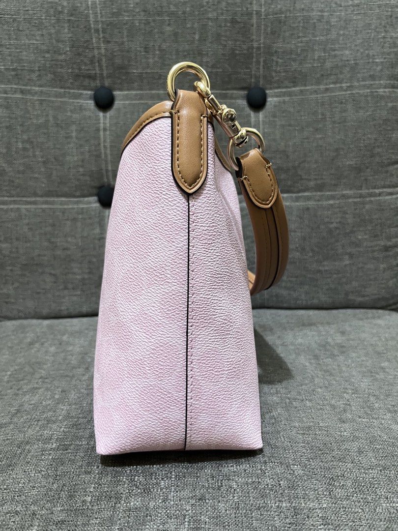Coach Laurel Bag from Hawaii (Category: Luxury Bags & Wallets) located in Manila. Submitted by zencat.93bfa9 (Listing ID 1467479524, Image 3). Description: - Brand: Coach - Color: Light pink with tan leather trim - Hardware: Gold-tone - Straps: Includes short shoulder strap and adjustable crossbody strap - Features: Signature Coach hangtag and structured flat bottom - Condition: Pristine, clean interior and exterior with no signs of wear.