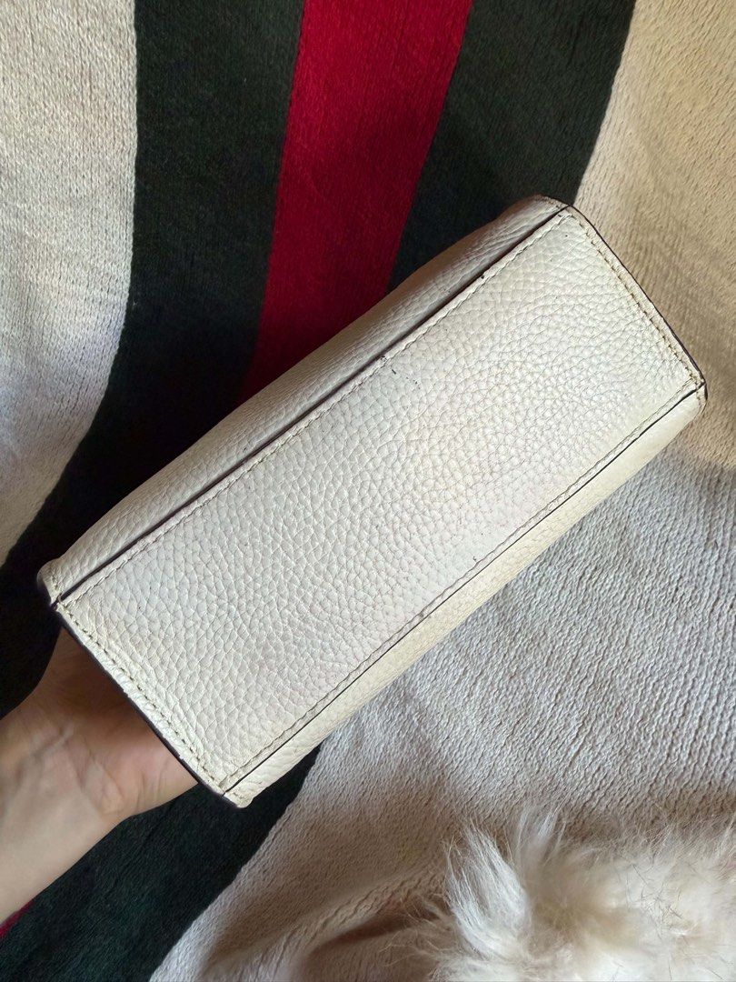 Coach Mini Tote Bag White Brown Leather (Category: Luxury Bags & Wallets) located in Bauang. Submitted by Fuzakenn (Listing ID 1467431941, Image 3). Description: - Brand: Coach - Style: Mini Tote / Crossbody - Color: Off-white pebble leather with dark brown handles - Hardware: Gold-tone - Interior: Brown fabric lining with creed patch (K2039-C2183) - Closure: Top flap with top handles - Inclusion: Matching adjustable leather crossbody strap - Con