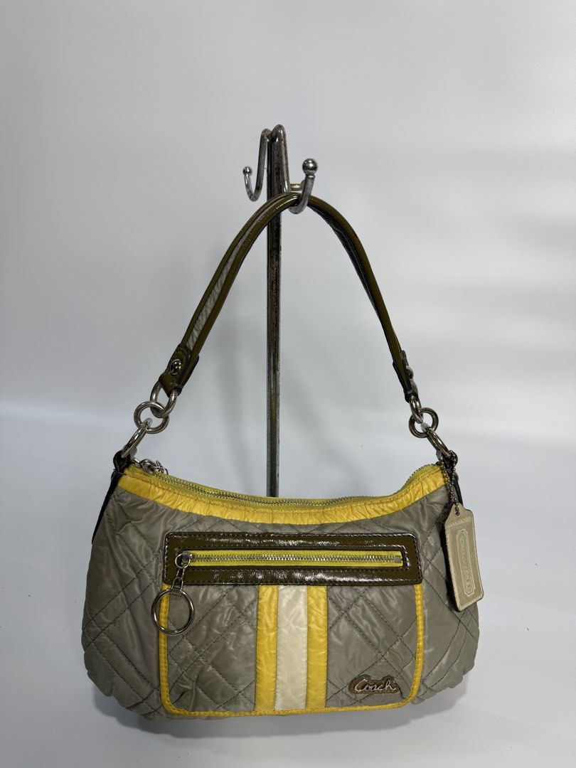 Coach Quilted Nylon Shoulder Bag Olive Green Yellow (Category: Luxury Bags & Wallets) located in Dasmarinas. Submitted by arjalaph (Listing ID 1467430121, Image 1). Description: - Authentic Coach shoulder bag in olive green and yellow quilted nylon - Front zip pocket with silver ring pulls and vertical stripe accent - Single dark green strap with edgy chain link attachments - Clean grey fabric lining with signature Coach branding - Includes origi