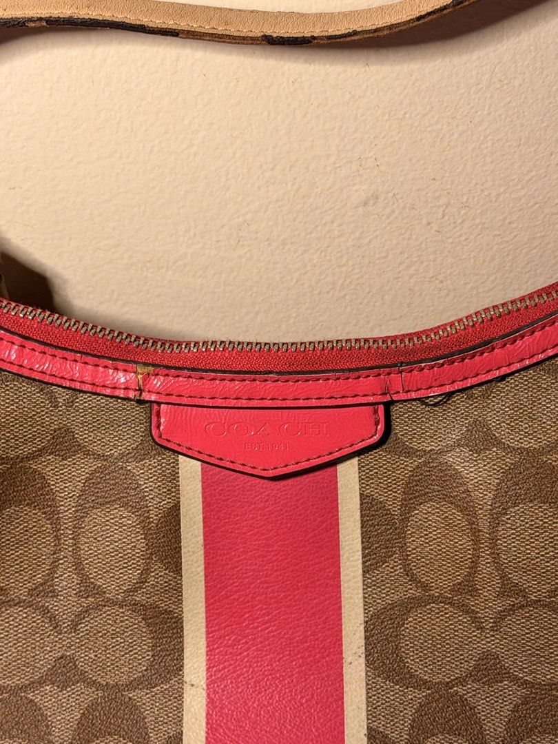 Coach Signature Stripe Demi (Category: Shoulder Bags) located in Daraga. Submitted by littlemissdeclutter.wtme (Listing ID 1467581145, Image 2). Description: Coach Signature Stripe Demi Crossbody in khaki and cerise/pink leather trim (no long strap) - which is a popular older style, likely from the 2000s or 2010s. It features the classic Coach signature canvas with a prominent vertical stripe and pink leather trim and straps. ⁃ kindly manage your