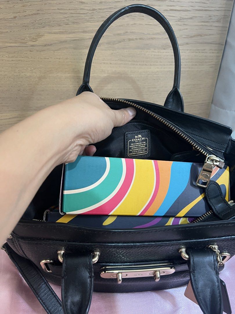 Coach Swagger (Category: Luxury Bags & Wallets) located in San Jose del Monte. Submitted by joy_ochoa (Listing ID 1467427509, Image 2). Description: Black pebble leather Coach bag with gold hardware. Turnlock closure on front, zipper top main compartment. Inside has a Coach storypatch and fabric lining. Dual top handles plus a removable, adjustable shoulder strap. Includes two Coach hangtags on the side. Fits daily essentials easily. .