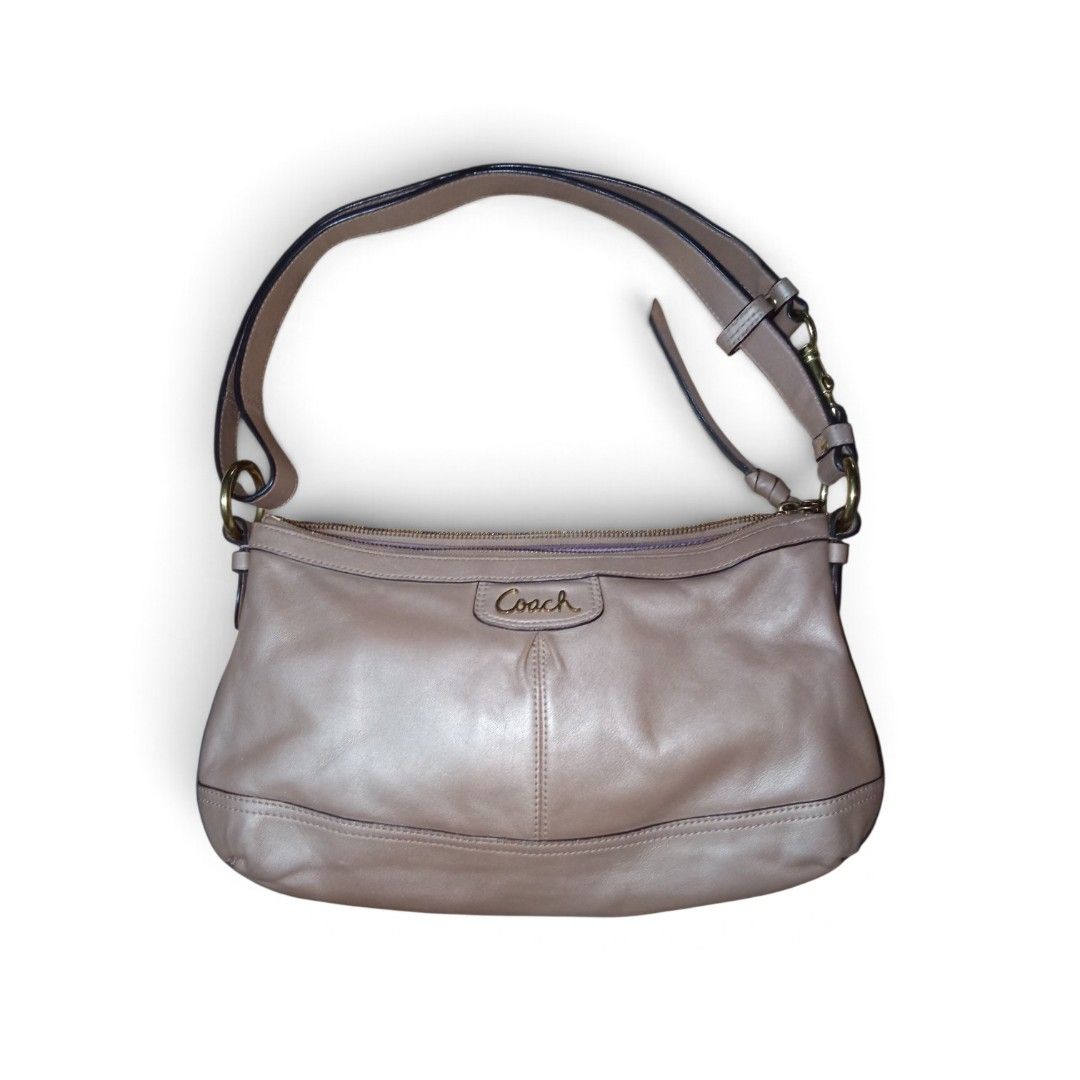 Coach Taupe Leather Shoulder Bag (Category: Luxury Bags & Wallets) located in Nagcarlan. Submitted by irishcasta73122 (Listing ID 1467373676, Image 1). Description: from Japan slightly negotiable issue po sa loob dirt - Brand: Coach - Color: Taupe - Material: Soft leather - Hardware: Gold-tone with front script logo plate - Closure: Secure zip top - Strap: Adjustable with brass side rings - Condition: Clean stitching and well-maintained.