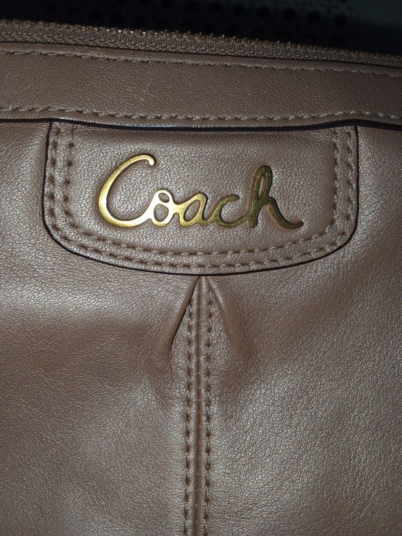 Coach Taupe Leather Shoulder Bag (Category: Luxury Bags & Wallets) located in Nagcarlan. Submitted by irishcasta73122 (Listing ID 1467373676, Image 3). Description: from Japan slightly negotiable issue po sa loob dirt - Brand: Coach - Color: Taupe - Material: Soft leather - Hardware: Gold-tone with front script logo plate - Closure: Secure zip top - Strap: Adjustable with brass side rings - Condition: Clean stitching and well-maintained.