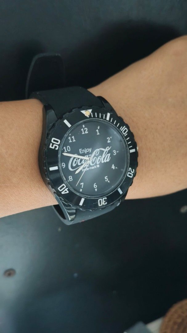Coca-Cola Black Silicone Strap Wrist Watch (Category: Men's Watches) located in Taguig. Submitted by mercyeugen28914 (Listing ID 1467450342, Image 3). Description: - Classic black analog watch with bold white numbers for easy reading - Comfortable black silicone strap featuring a bright red Coca-Cola logo - Stylish rotating bezel - Secure standard pin buckle closure - Fun and collectible piece for Coca-Cola fans 45 mm including the crown 9 inches