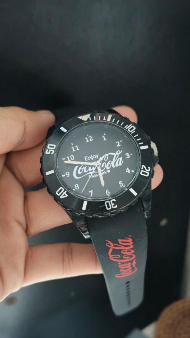 Coca-Cola Black Silicone Strap Wrist Watch (Category: Men's Watches) located in Taguig. Submitted by mercyeugen28914 (Listing ID 1467450342, Image 2). Description: - Classic black analog watch with bold white numbers for easy reading - Comfortable black silicone strap featuring a bright red Coca-Cola logo - Stylish rotating bezel - Secure standard pin buckle closure - Fun and collectible piece for Coca-Cola fans 45 mm including the crown 9 inches