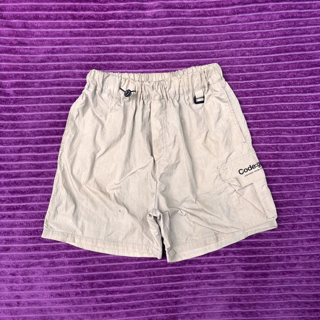 Codegraphy Utility Function Cargo Shorts Beige Size M (Category: Shorts) located in Manila. Submitted by loydgani (Listing ID 1467467358, Image 1). Description: - Brand: Codegraphy - Item: Utility Cargo Shorts - Color: Beige - Size: Medium (M) - Material: Lightweight nylon with interior black mesh lining - Waistband: Elastic with drawstring and black toggle - Pockets: Side cargo pocket with text branding and back pocket with CGP logo tag - Condit