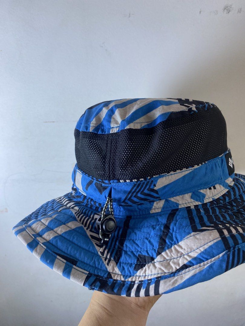 Columbia Omni-Shade Blue Patterned Bucket Hat (Category: Caps & Hats) located in Manila. Submitted by kennyfranc39614 (Listing ID 1467514761, Image 2). Description: - Brand: Columbia - Item: bucket hat - Color/Pattern: Bright blue geometric - Features: Omni-Shade sun protection, mesh band for airflow, adjustable toggle cinch cord - Material: 100% nylon shell - Size: 56cm - Condition: Clean interior with tag intact.