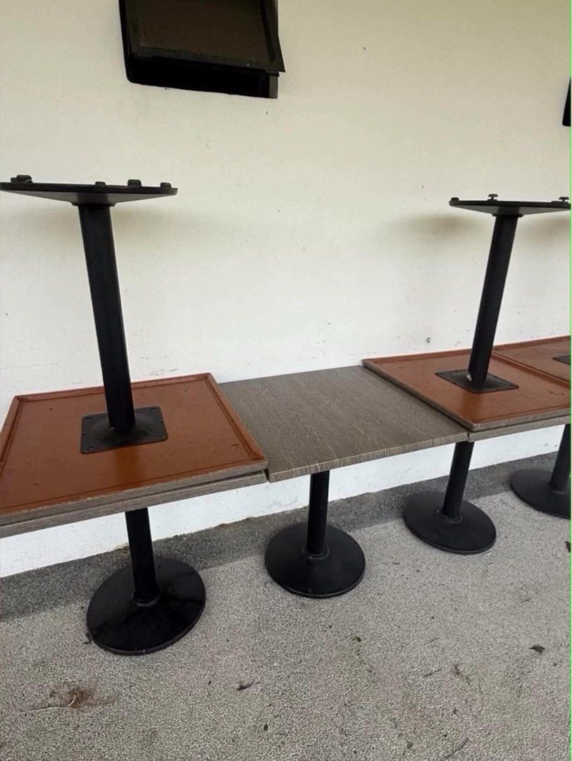 Commercial Cafe Dining Tables with Black Pedestal Base (Category: Tables & Sets) located in Manila. Submitted by marquezpa52205 (Listing ID 1467401920, Image 1). Description: - Type: Square café/restaurant tables - Base: Sturdy black metal pedestal with round floor plate - Tops: Wooden finish (mix of brown and grey wood grain, reversible) - Build: Heavy-duty, ideal for commercial or office use - Availability: Multiple units available, buy as a se