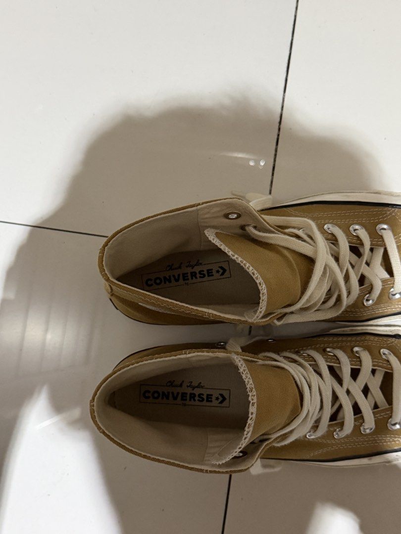 Converse Chuck 70 High Top mustard yellow (Category: Casual Shoes) located in Manila. Submitted by hatdognablue (Listing ID 1467403266, Image 3). Description: - Style: mustard yellow canvas high tops with classic Chuck Taylor ankle patch - Details: White laces, rubber toe caps, cushioned insoles, and sturdy rubber outsoles with diamond tread - Condition: Minor scuffs on the white midsoles from normal wear. RARELY USED. - Fit/Vibe: Great everyday 