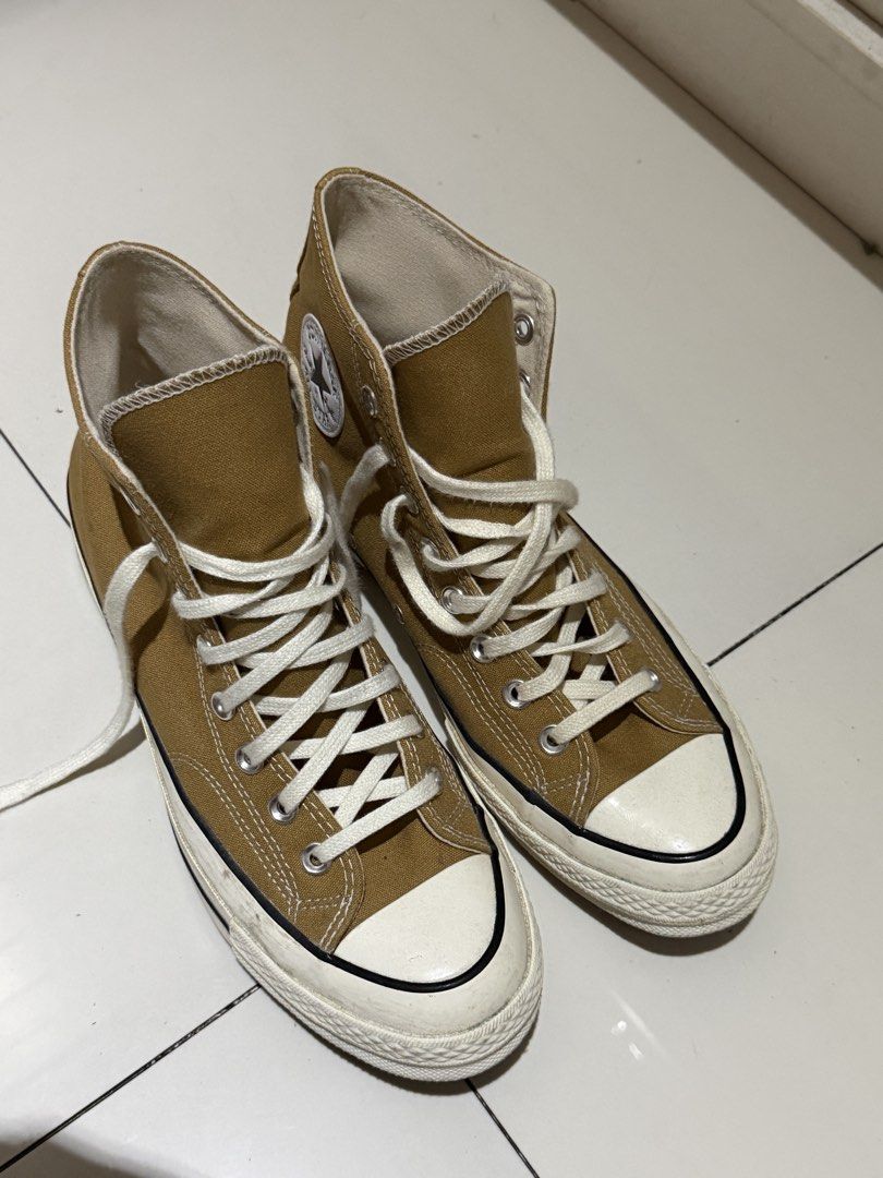 Converse Chuck 70 High Top mustard yellow (Category: Casual Shoes) located in Manila. Submitted by hatdognablue (Listing ID 1467403266, Image 2). Description: - Style: mustard yellow canvas high tops with classic Chuck Taylor ankle patch - Details: White laces, rubber toe caps, cushioned insoles, and sturdy rubber outsoles with diamond tread - Condition: Minor scuffs on the white midsoles from normal wear. RARELY USED. - Fit/Vibe: Great everyday 