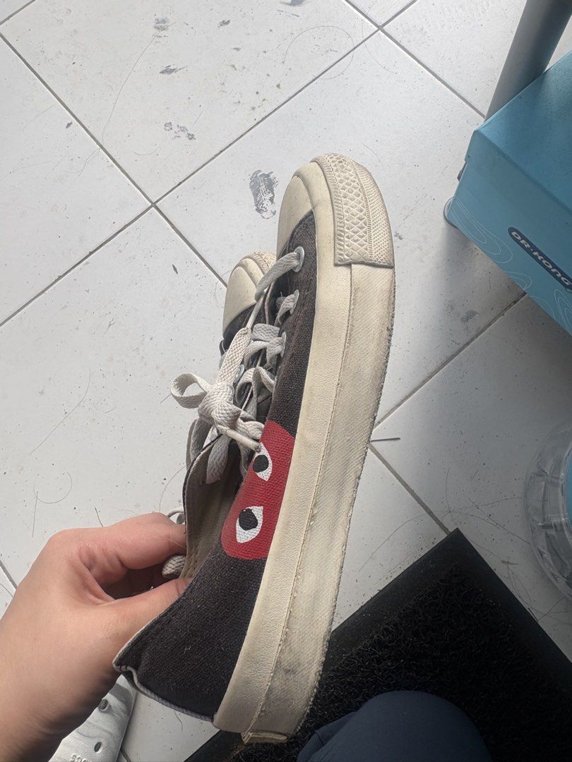 Converse x Comme des Garcons PLAY Black Low Top (Category: Sneakers) located in Davao. Submitted by maycelle (Listing ID 1467597167, Image 2). Description: - Brand: Classic collaboration canvas sneakers - Design: Black low-top with iconic red heart and eyes logo - Details: White laces and durable rubber toe caps - Size: US 5 / JPN 24 - Condition: Soles show minor wear and dirt from previous use, still great for streetwear fits.