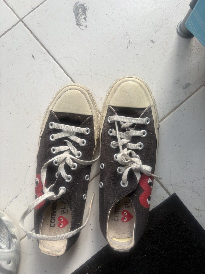 Converse x Comme des Garcons PLAY Black Low Top (Category: Sneakers) located in Davao. Submitted by maycelle (Listing ID 1467597167, Image 1). Description: - Brand: Classic collaboration canvas sneakers - Design: Black low-top with iconic red heart and eyes logo - Details: White laces and durable rubber toe caps - Size: US 5 / JPN 24 - Condition: Soles show minor wear and dirt from previous use, still great for streetwear fits.