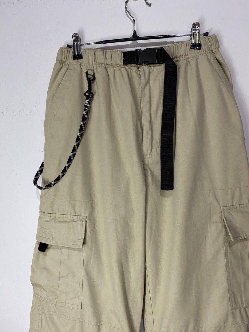 CONVERTABLE INTO SHORT (Category: Jeans) located in Jaen. Submitted by oshimamark58418 (Listing ID 1467451780, Image 3). Description: - Brand: CRU - Style: Convertible cargo pants (zips off into shorts) - Color: Beige / Khaki - Size: 30 - Features: Multiple functional cargo pockets, built-in black quick-release belt, decorative lanyard/key ring, and adjustable drawstring hems - Condition: Excellent pre-owned condition - Perfect for outdoor activi