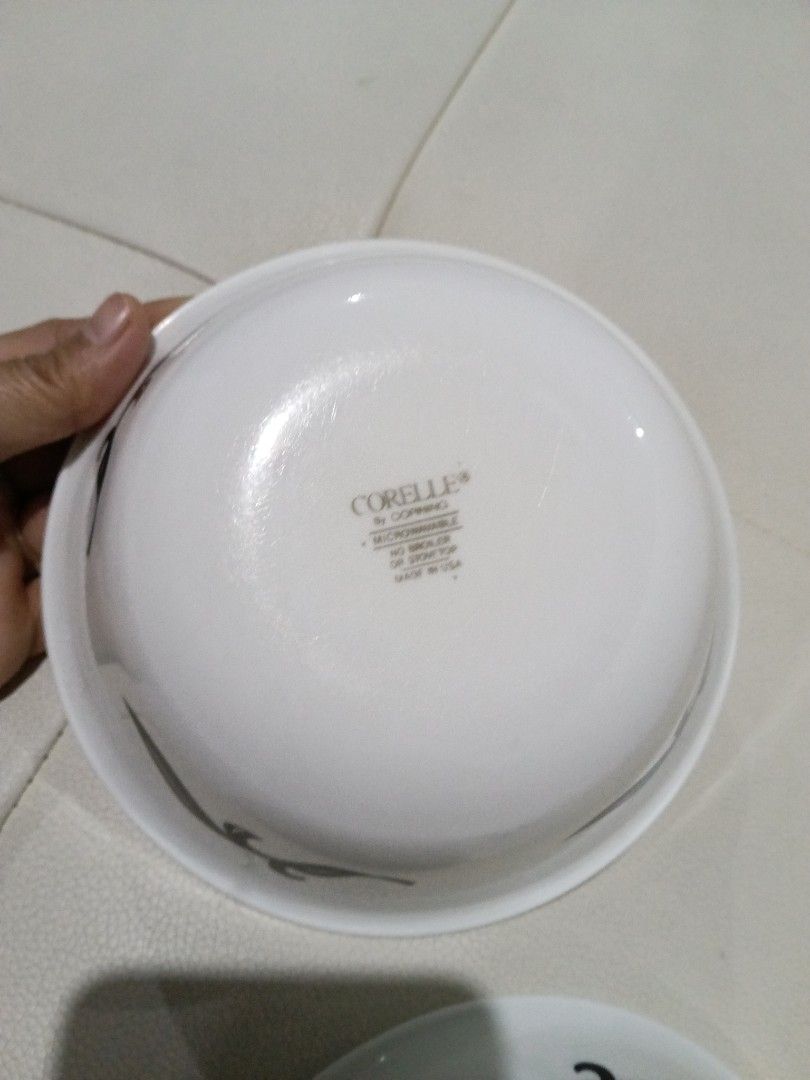 Corelle by Corning bowls with black leaf pattern (Category: Dinnerware & Cutlery) located in Manila. Submitted by zenbear_6b2d8a (Listing ID 1467387778, Image 2). Description: - Authentic Corelle by Corning bowls (Set of 2) - Features an elegant black leaf vine pattern - Standard size, ideal for cereal, soup, or desserts - Microwave safe and proudly made in the USA - Clean bottoms with glossy, intact white glaze.