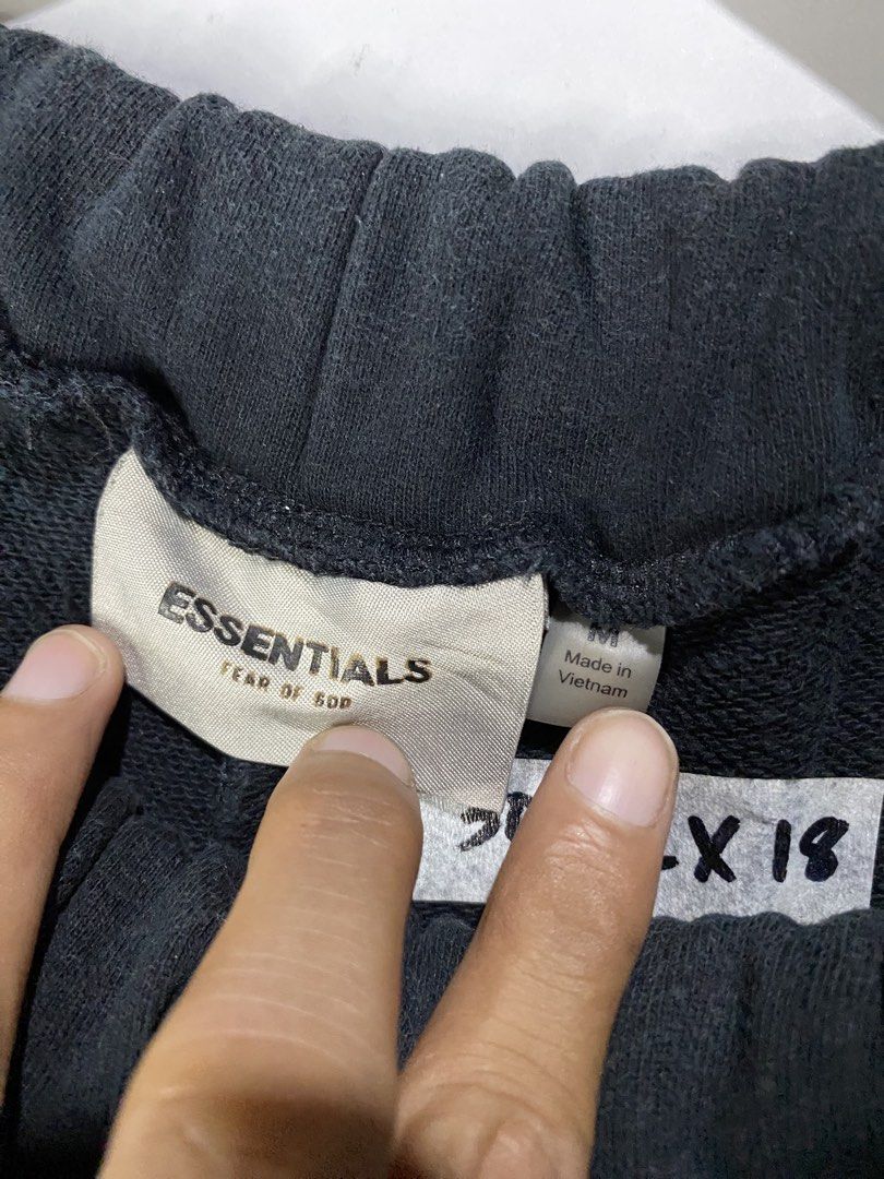 COTTON SHORTS (Category: Shorts) located in Jaen. Submitted by oshimamark58418 (Listing ID 1467513196, Image 3). Description: - Brand: ESSENTIALS Fear of God - Color: Black with cream side stripes - Size: Medium (Waist: 30-32, Length: 18) - Material: 100% Cotton - Style: Casual streetwear, comfortable fit with elastic waistband and pockets - Condition: Good pre-owned condition.