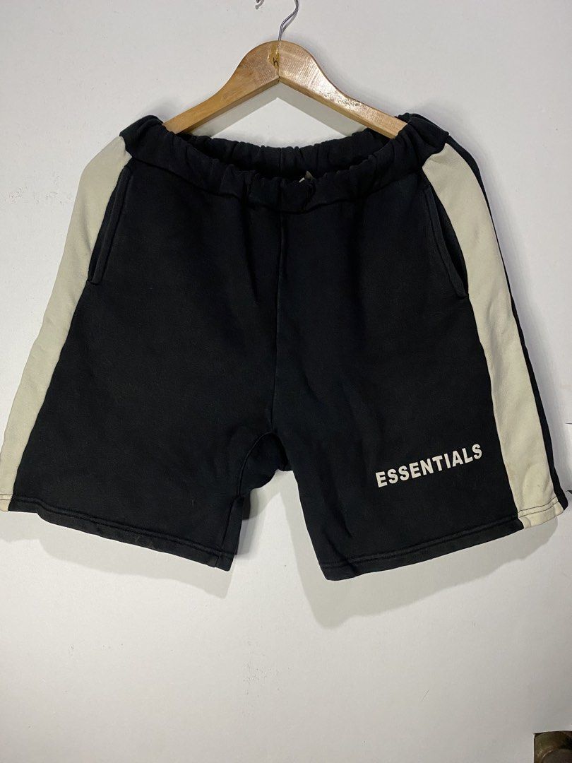 COTTON SHORTS (Category: Shorts) located in Jaen. Submitted by oshimamark58418 (Listing ID 1467513196, Image 1). Description: - Brand: ESSENTIALS Fear of God - Color: Black with cream side stripes - Size: Medium (Waist: 30-32, Length: 18) - Material: 100% Cotton - Style: Casual streetwear, comfortable fit with elastic waistband and pockets - Condition: Good pre-owned condition.
