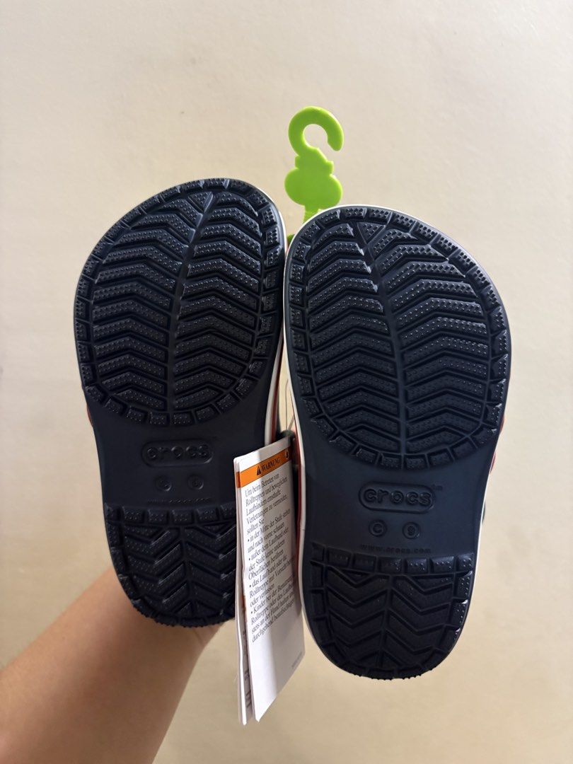 Crocs (Category: Babies & Kids Fashion) located in Mabalacat. Submitted by fhey.09 (Listing ID 1467437528, Image 3). Description: - Brand: Crocs - Color: Navy blue with white and red midsole logo - Size: US C9 / EUR 25-26 / 155mm - Condition: Brand new with original tags in plastic packaging Rfs: malaki size sa baby ko 😊.