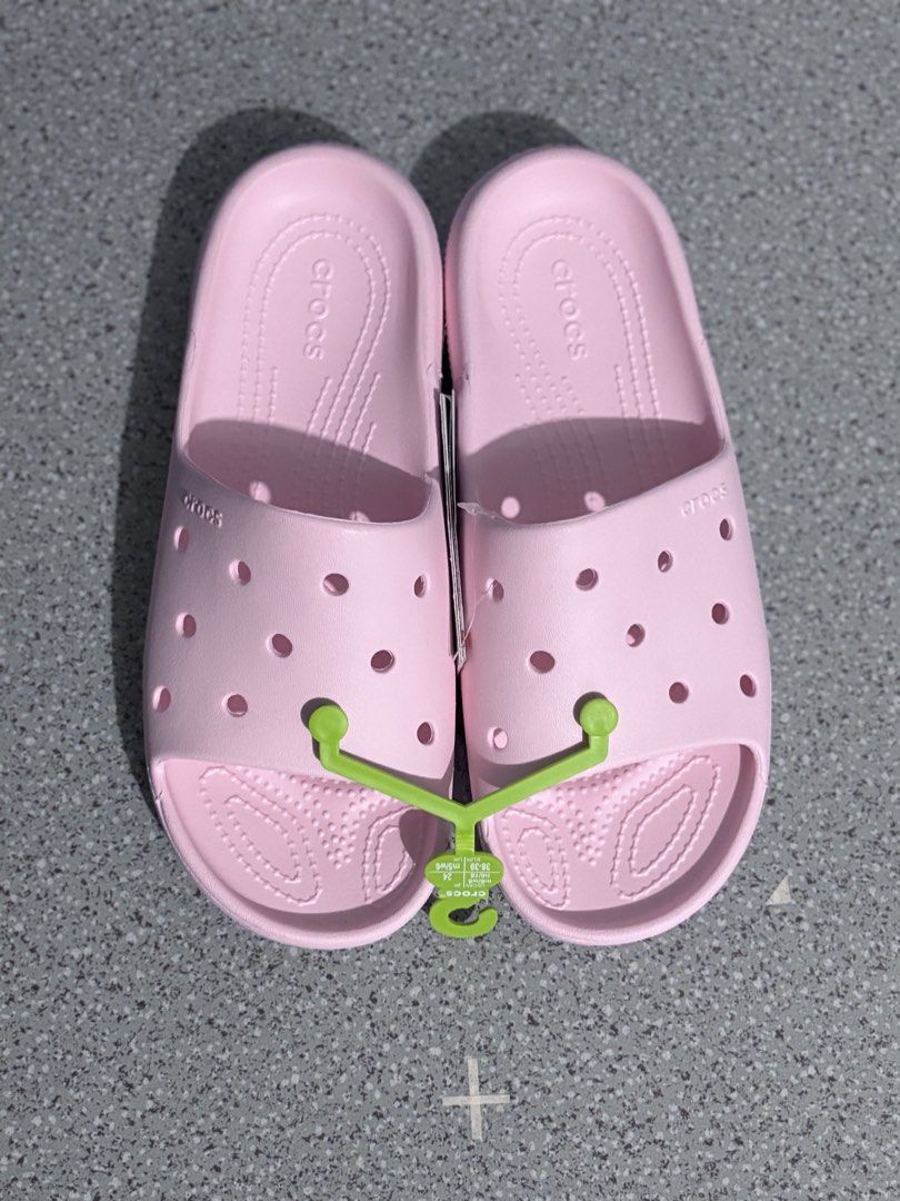 Crocs Classic Slide V2 Pink Sandals (Category: Slippers and slides) located in Quezon City. Submitted by capableturtle_25 (Listing ID 1467480279, Image 3). Description: - Item: Crocs Classic Slide V2 - Color: Pink - Condition: Brand new with tags, still in original plastic packaging - Features: Easy slip-on design, breathable upper ventilation holes, and textured footbed for extra grip - Perfect for casual wear, errands, or lounging.
