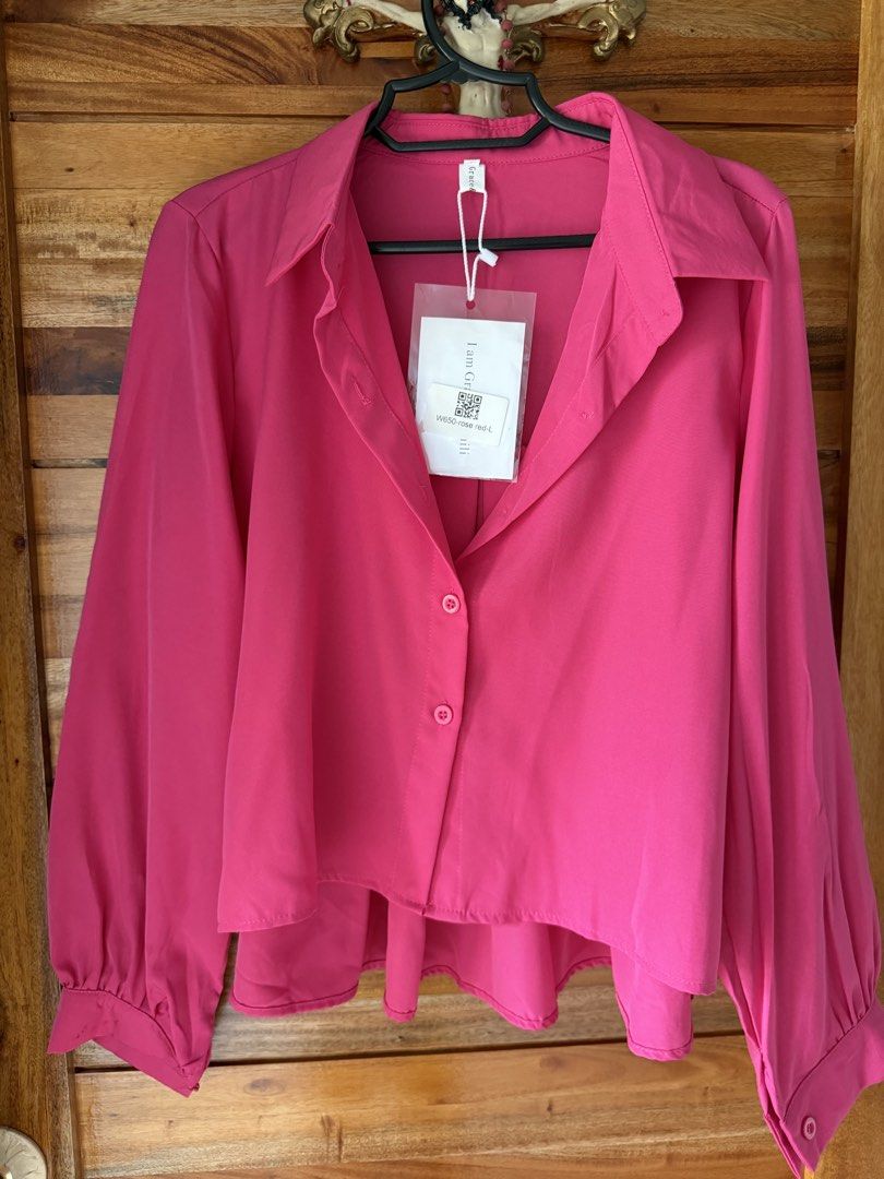 Crop Polo Button-Down L-XL (Category: Blouses) located in Manila. Submitted by poreberqueeen (Listing ID 1467370092, Image 1). Description: Bought it in BKK - Brand: Grace & Chili - Color: Rose Red - Condition: Brand new with original tags attached - Design: Button-up shirt with collared neckline - Sleeves: Long balloon sleeves with cuffed wrists - Hemline: High-low (shorter front, longer back) - Fabric: Lightweight with a smooth finish.