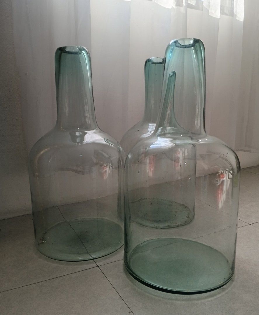 Damajuana/Demijohn Bottle (Category: Vases & Decorative Bowls) located in Quezon City. Submitted by pile.of.stuff (Listing ID 1467386225, Image 1). Description: Damajuana/Demijohn Bottle - Crafted from thick, heavy-duty recycled glass with a sturdy base - Ideal rustic decor piece for living room corners, entryways, or hallways - used once for an event - Dimensions: - 5 Units Available.